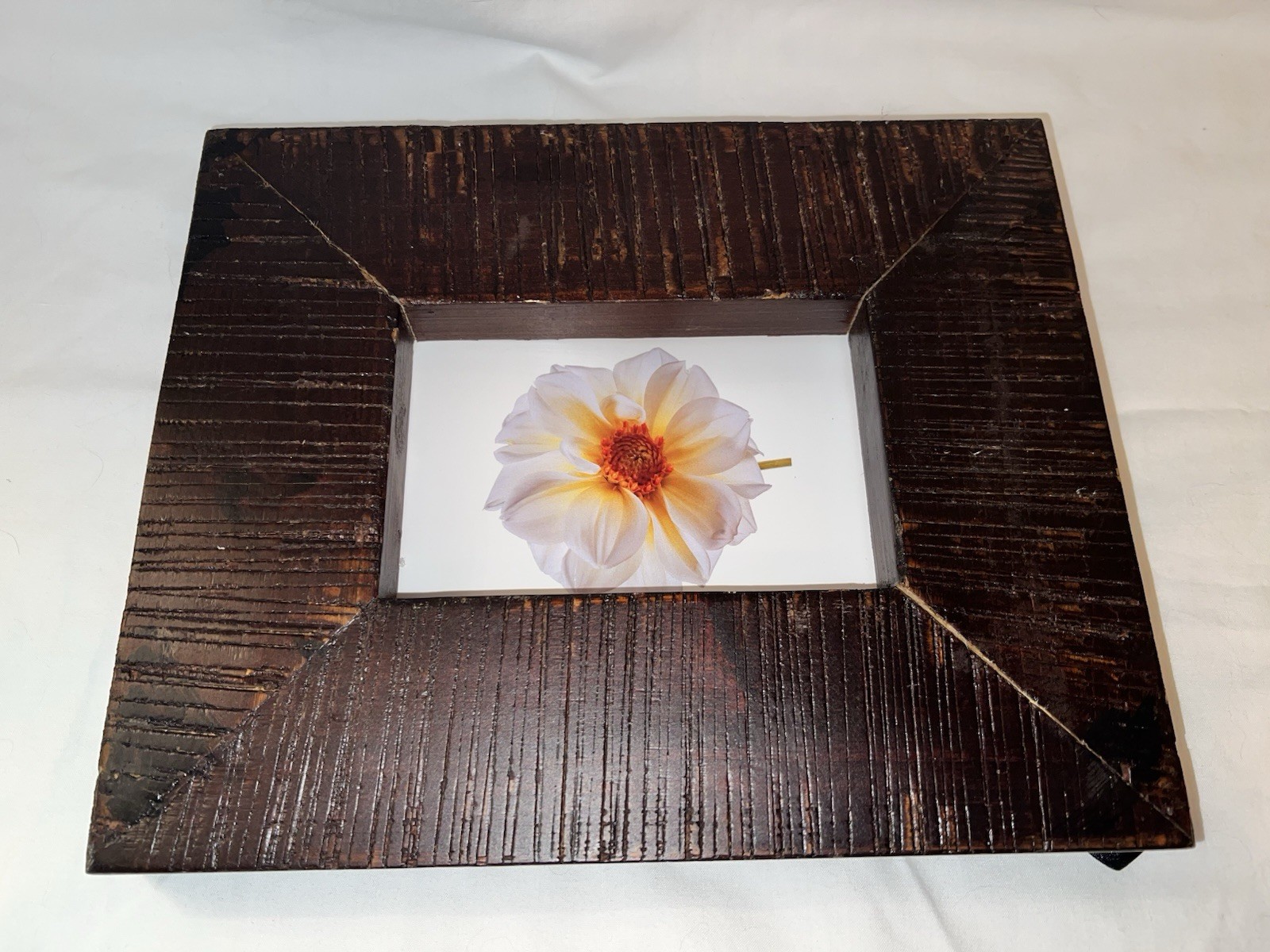 Rustic Wood frame with deep vertical grooves & finished in a dark, rich walnut gallery