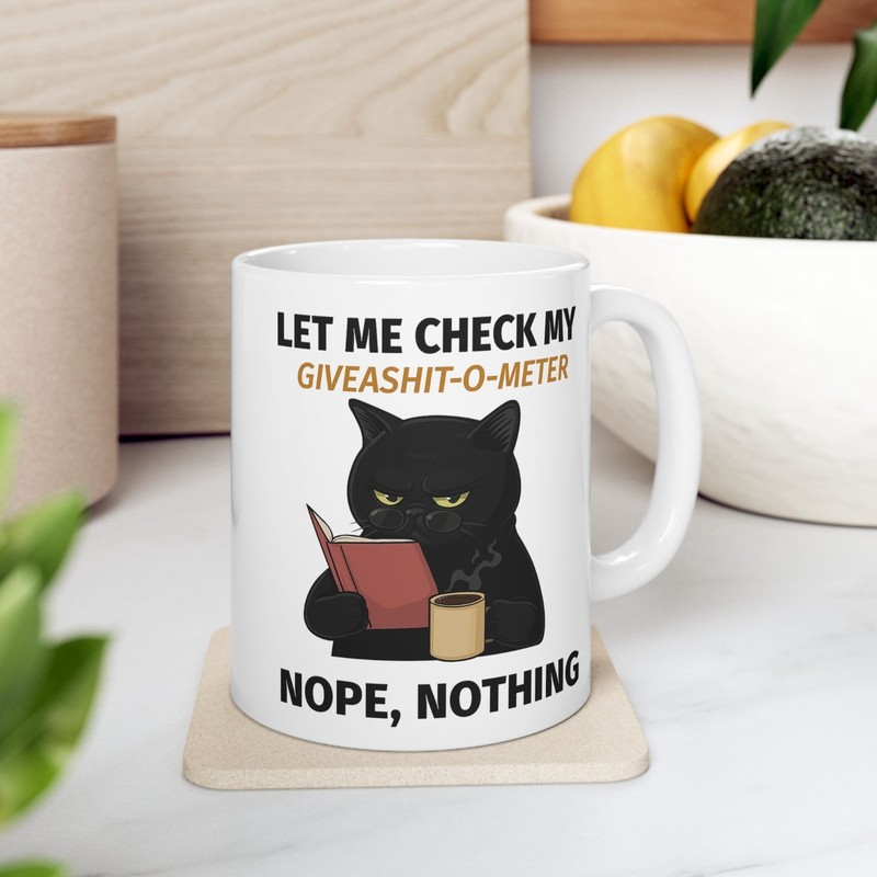 Funny Cat drinking Coffee Mug Stating "Let Me check my Give-o-Shit meter"Nope gallery