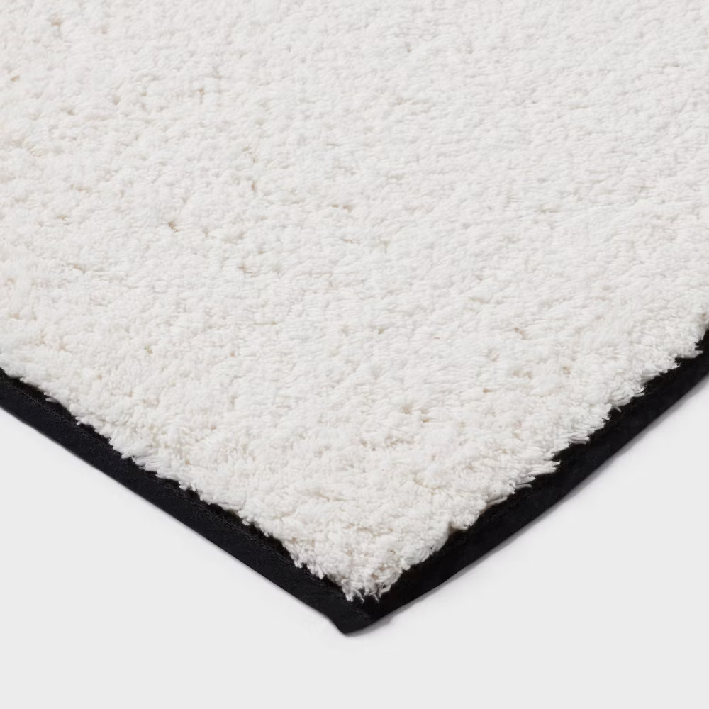 24"x36" Oversized Border Bath Rug Black/White - Threshold gallery