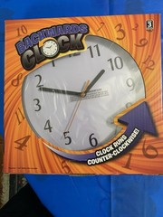 Funny Black Backwards Wall Clock (9″) Large Numbers. Runs Counterclockwise NEW