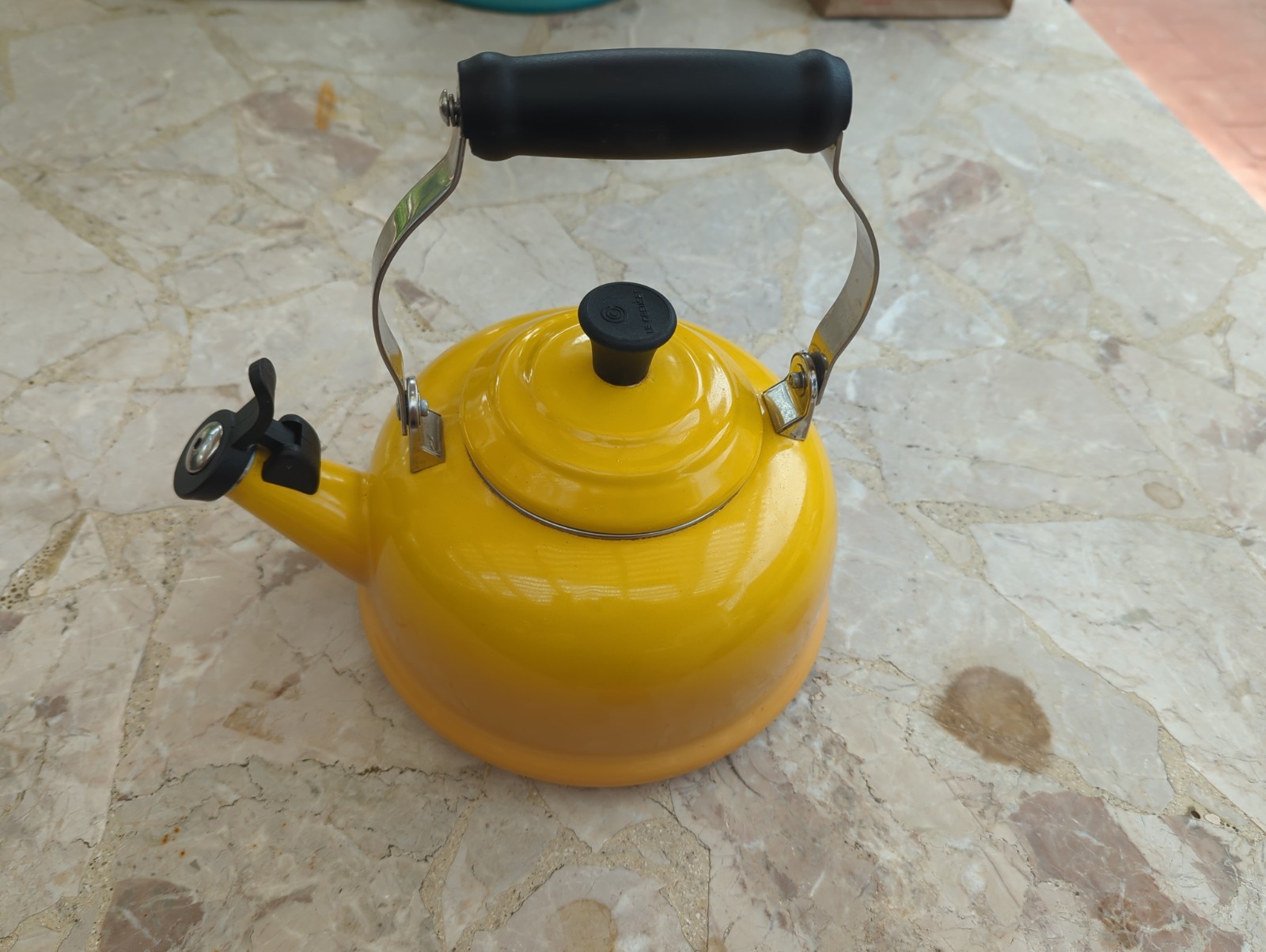Yellow Le Creuset Classic Whistling Tea Kettle with a black handle. gallery