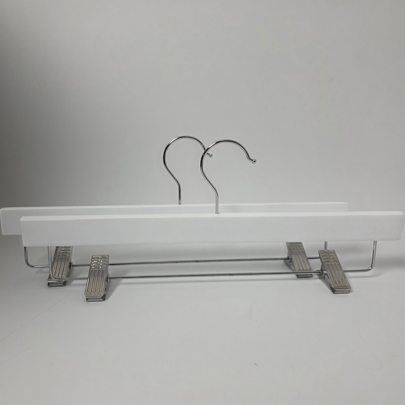 Two Pack White Wood Pant Hangers with Adjustable Metal Clips and Swivel Hook gallery