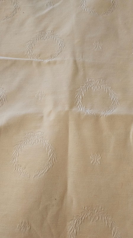 Cream colored table runner with tassled ends and wreath pattern 66 x 13 1/2 in gallery