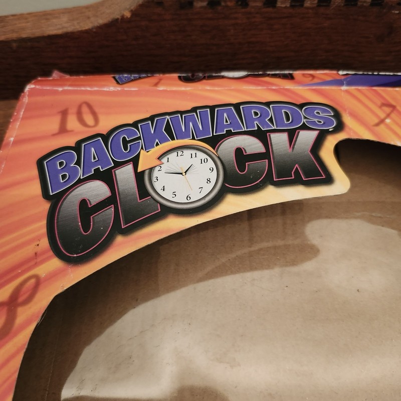 Funny Black Backwards Wall Clock (9") Large Numbers. Runs Counterclockwise gallery