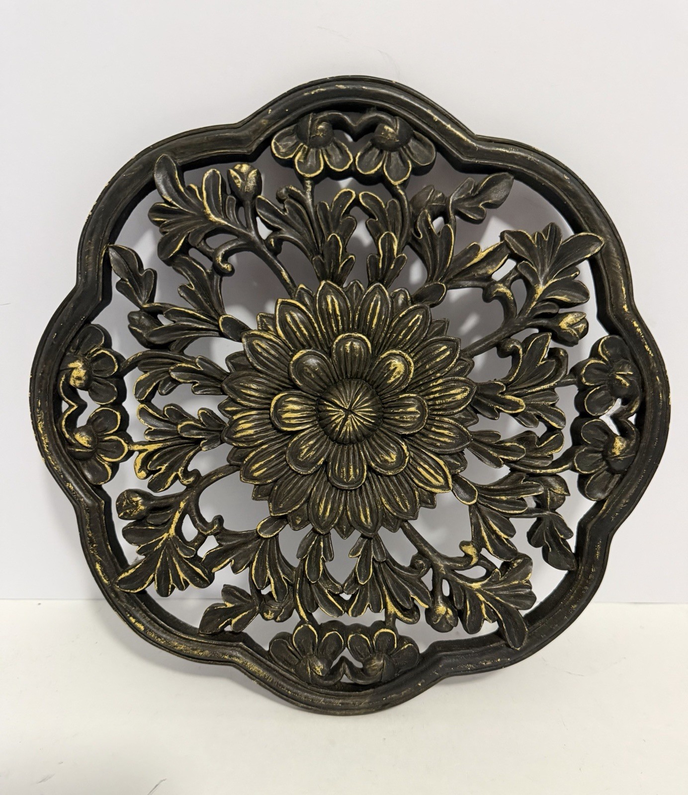 floral wall medallion featuring a black and gold patina finish gallery